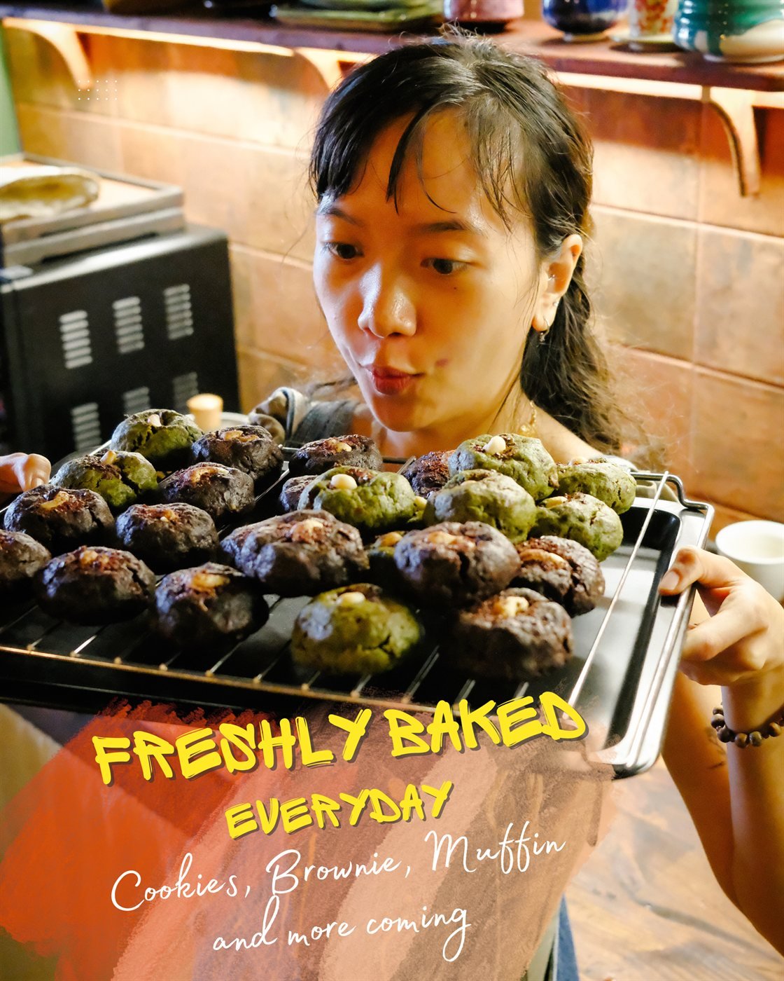 Freshly baked every day: tray of homemade cookies, brownies and chocolate and matcha muffins