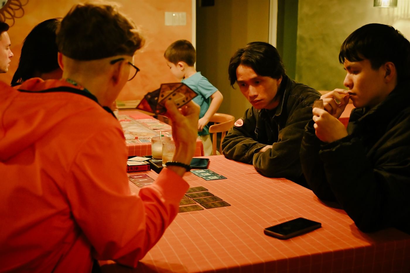 Friends playing cards at Game Night
