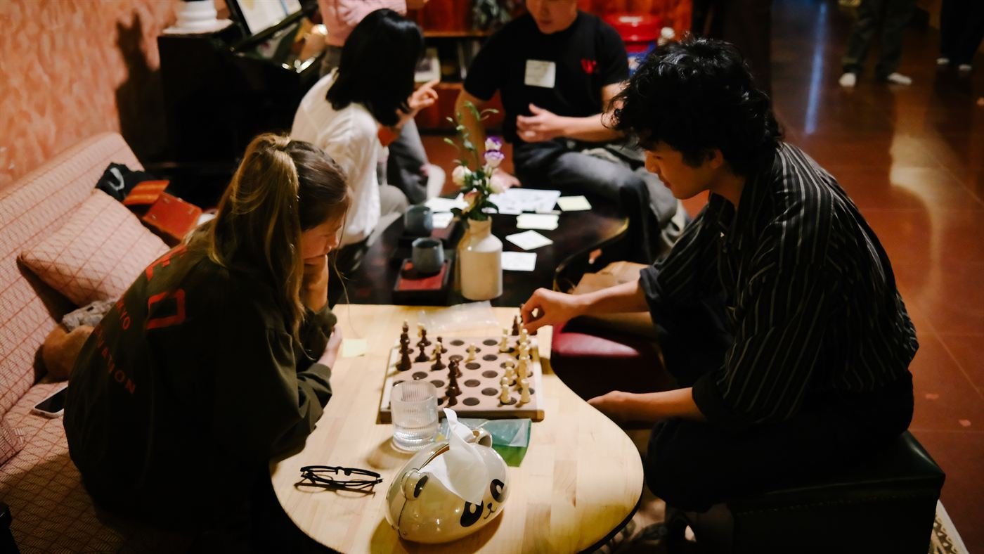 Guests playing chess during the Language Exchange