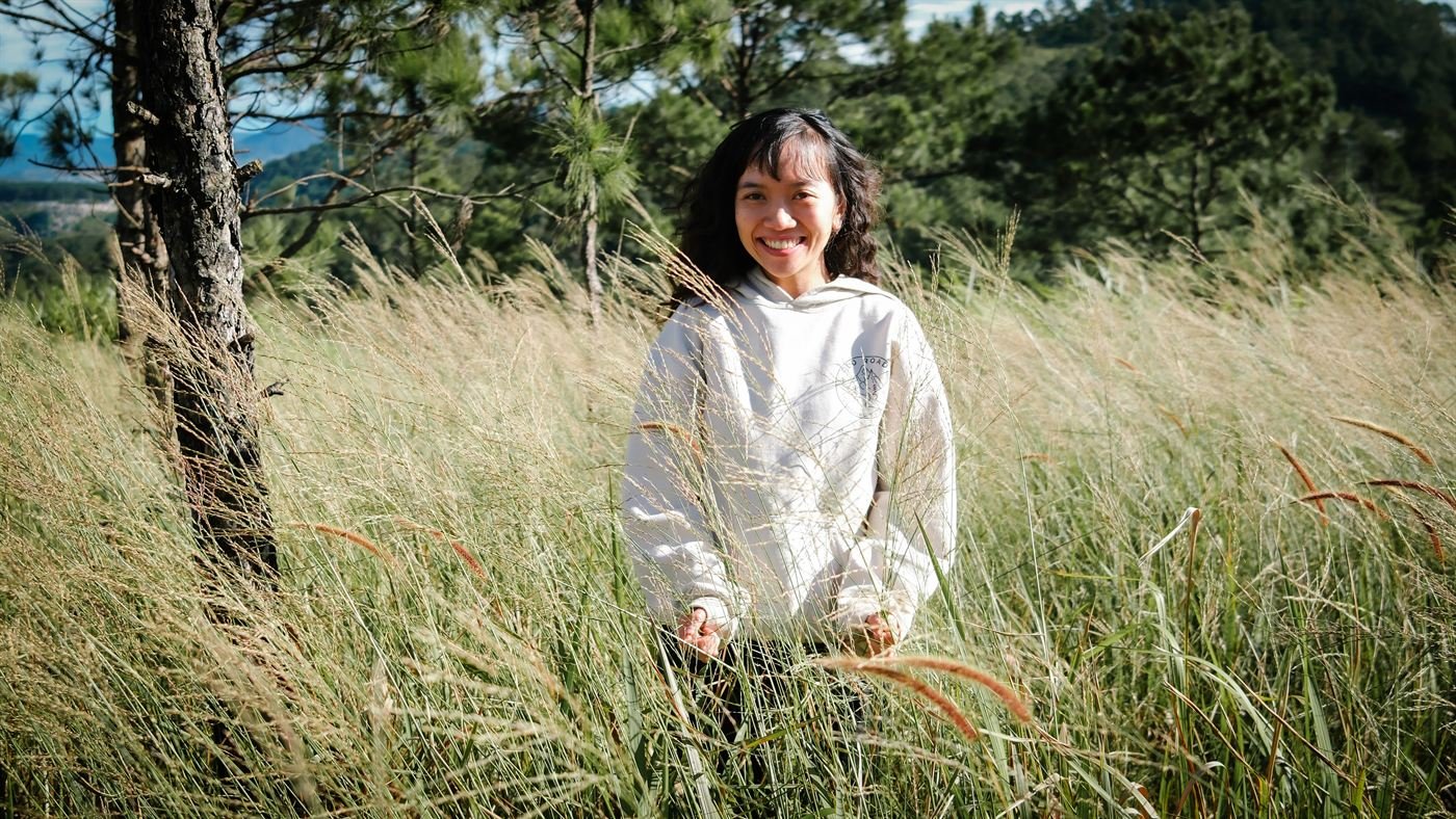 Smiling in the golden grass on the hill