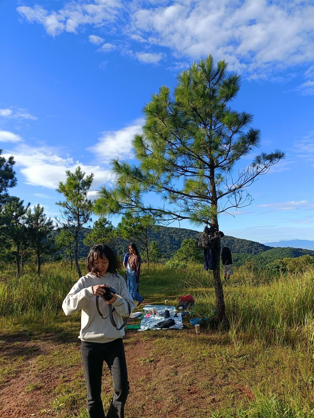 Taking photos on the hill under a blue sky